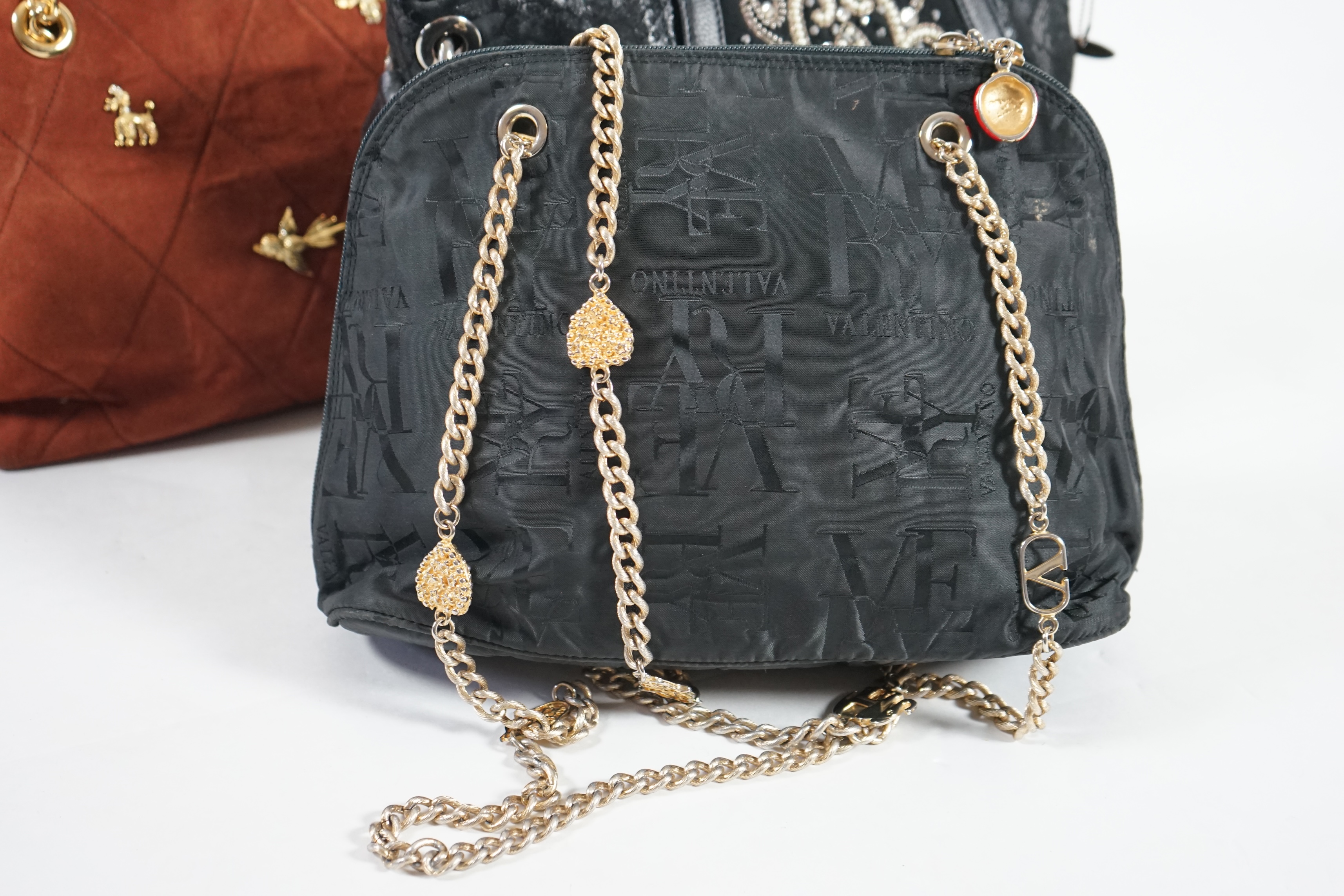 A selection of lady's handbags including a VERY Valentino black canvas bag with gold decorated chain handles, a Mary Frances black suede faux snake skin print shoulder bag with embellished fastening, a tan suede shoulder